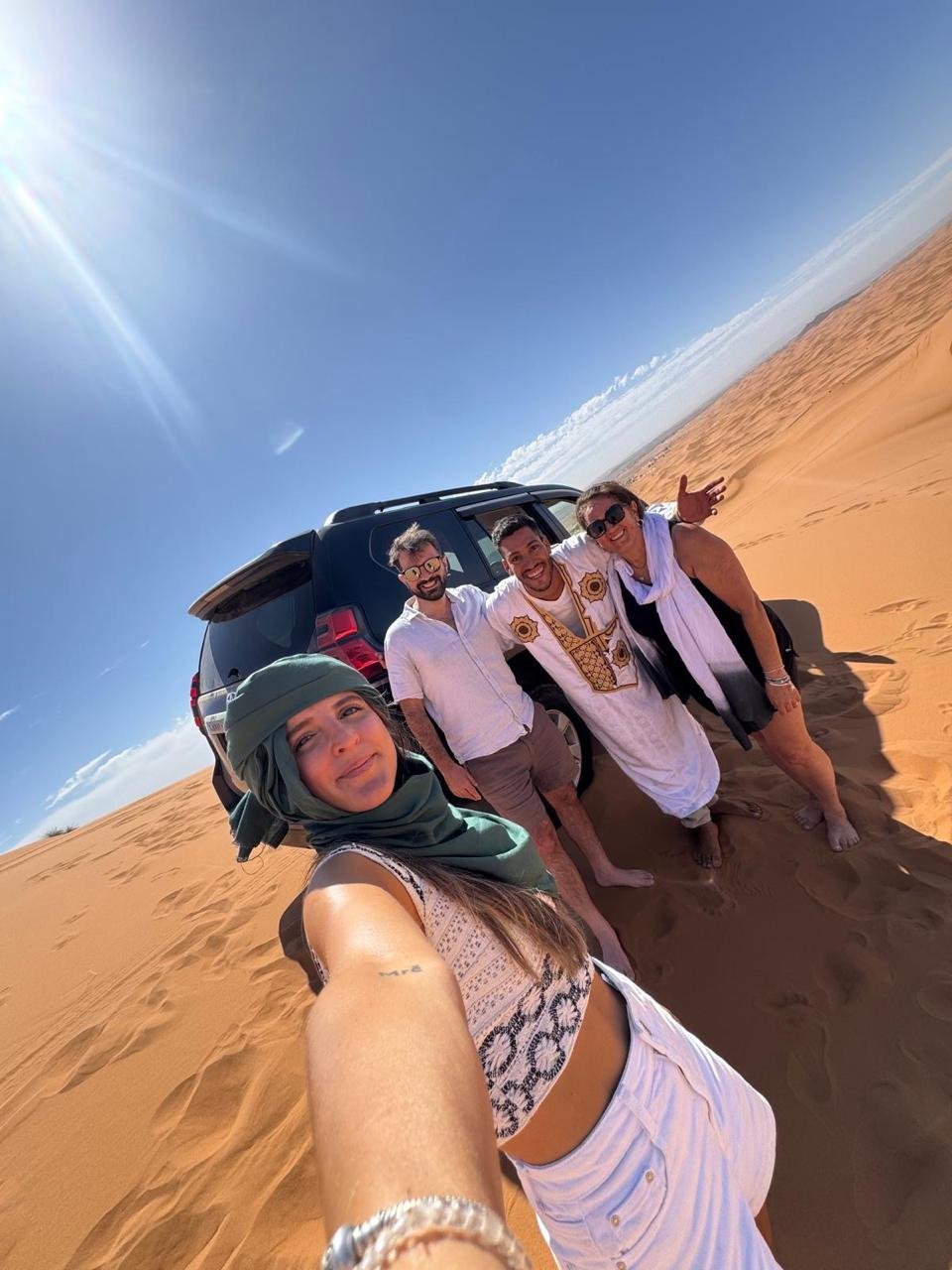 Travellers with Amar in the Sahara desert — Edita Morocco Tours